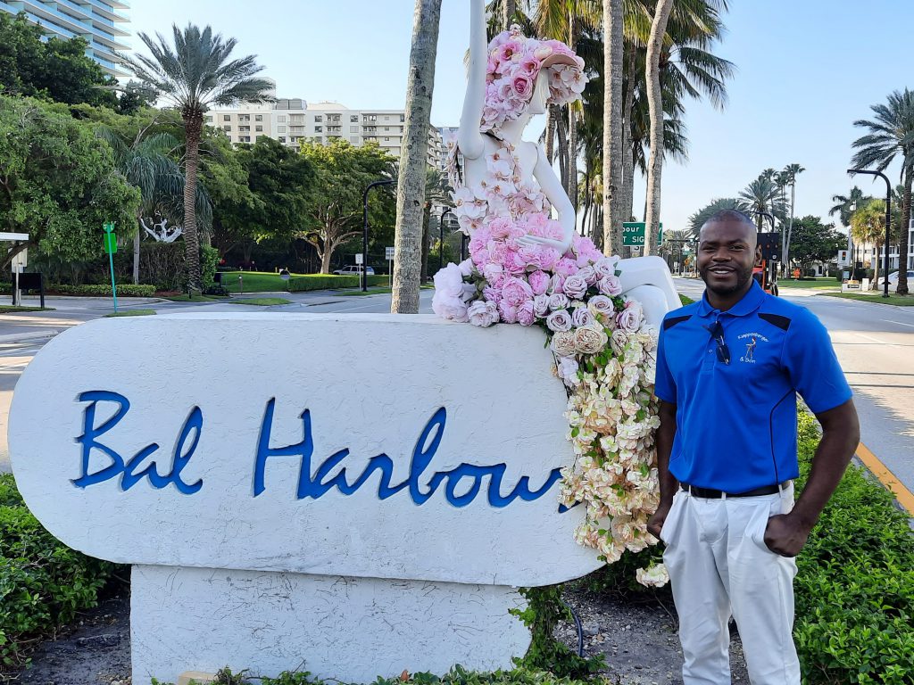 Miami painting contractor Rasheed Bowen standing in front of Bal Harbour sign