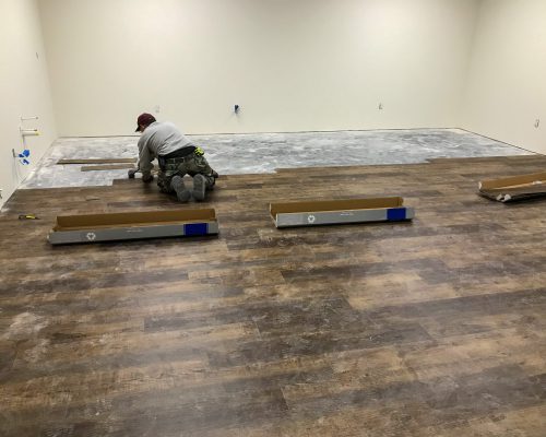 Laminate flooring Installation with man installing